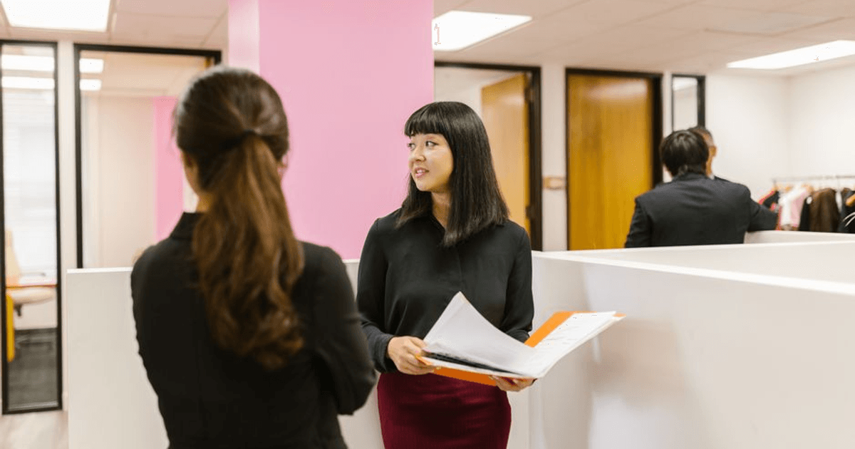 HR and finance reviewing an offer approval workflow on a shared screen